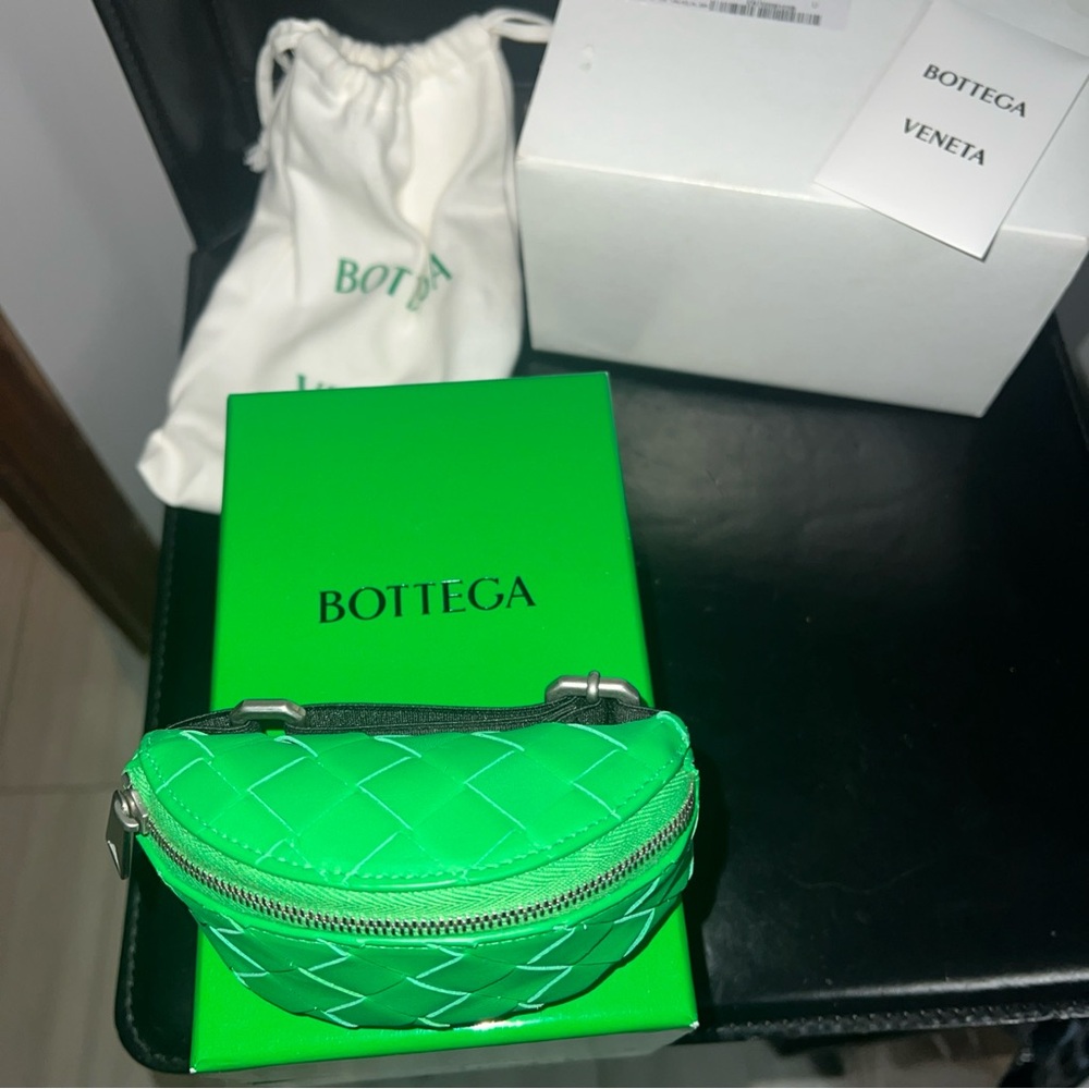 Bottega Veneta wrist pouch in parakeet green.